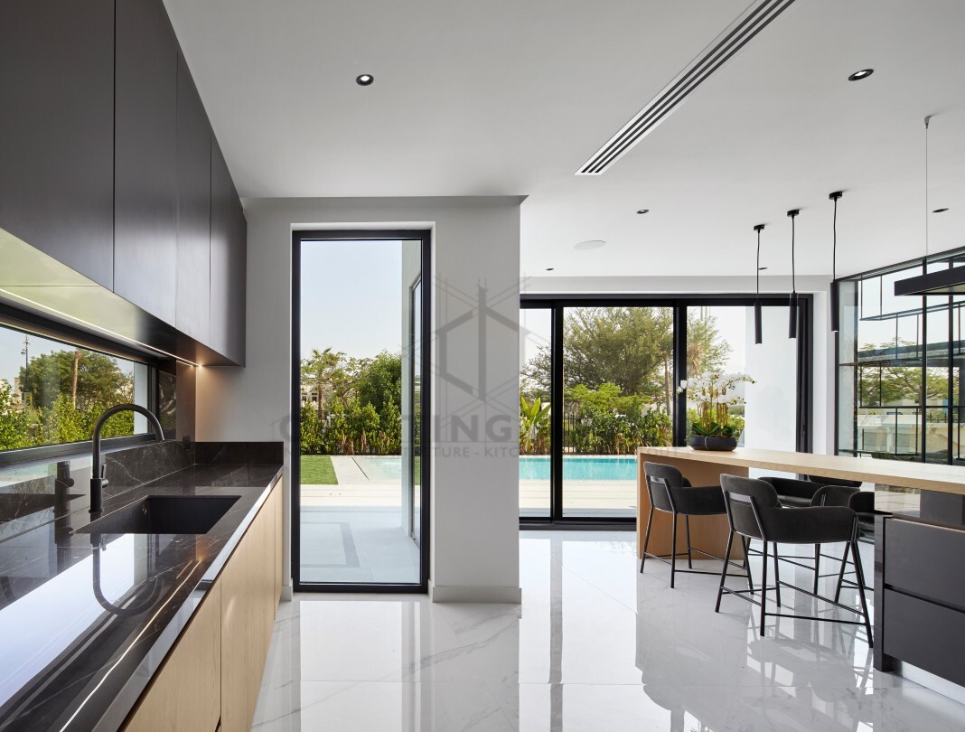 Creating Homes' modern kitchen with an elegant dining area, featuring a large wooden table, stylish chairs.