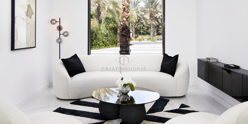 Creating Homes' Stylish modern interior showcasing a bright living room with contemporary furniture, large windows, and decorative plants